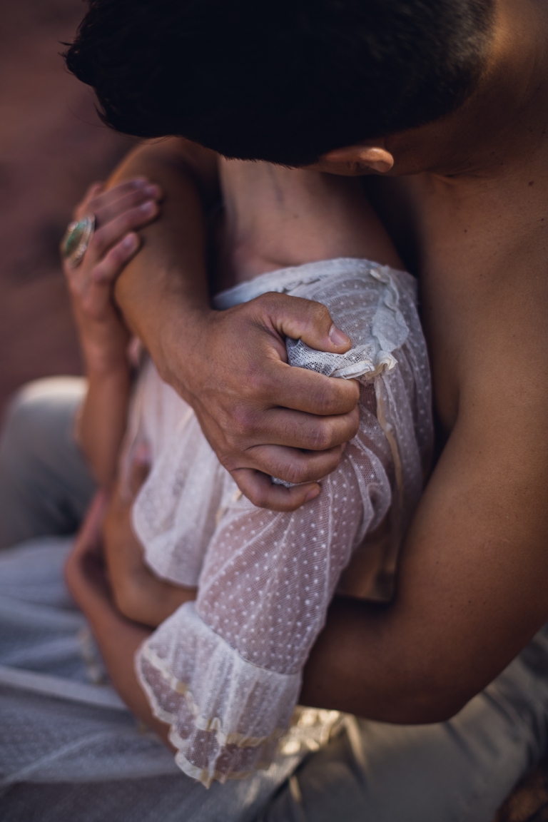 man embraces woman tightly during intimate sedona couples photography session