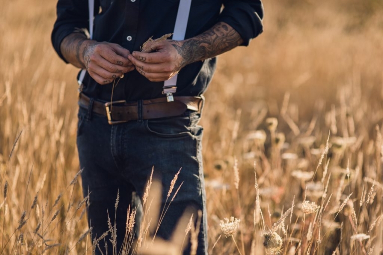 groom in golden wheat field