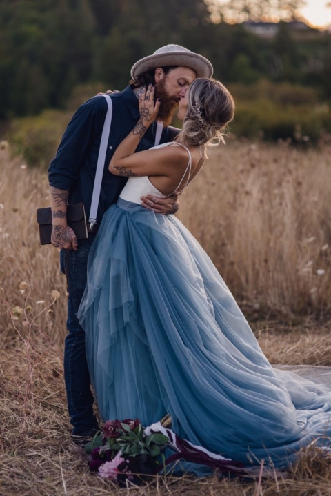 adventurous couple first kiss during wheat field elopement