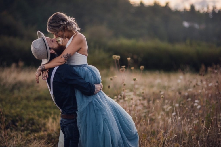 adventurous groom holding bride during elopement