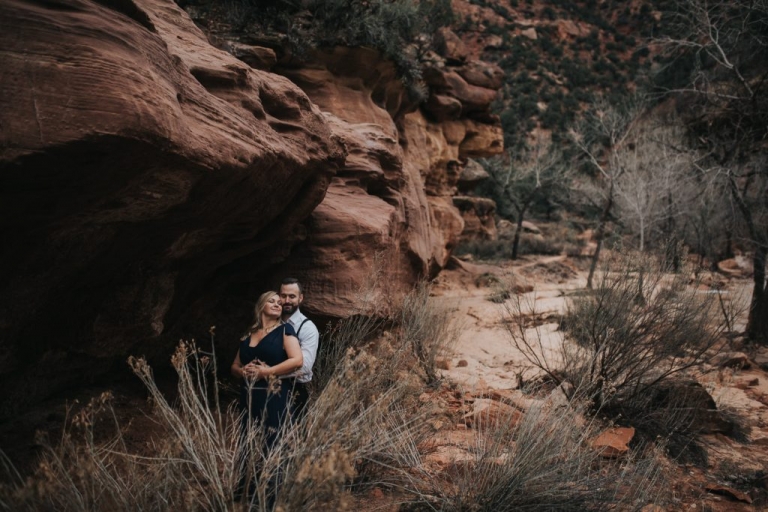 zion national park couples session in rock outcropping
