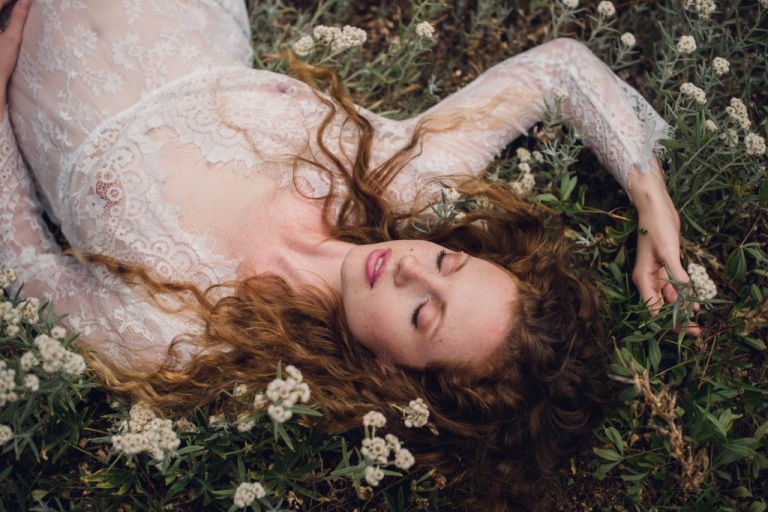 white dress redhead lady resting in white flower field olypmic washington