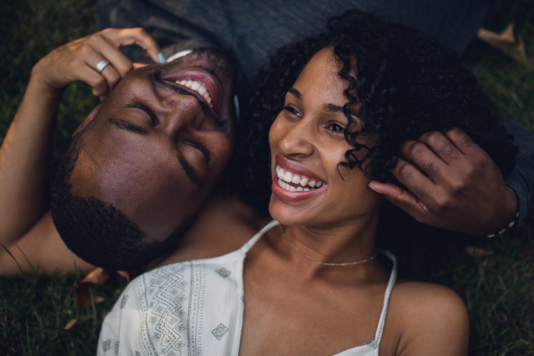 couple laying down laughing during adventure session in virginia