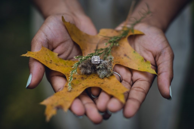 square cut diamond engagement ring on yellow leaf