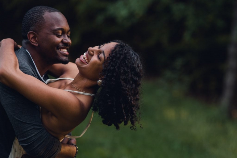couple leaning back and laughing during adventure session