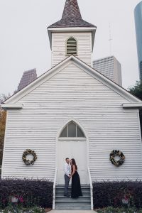 engagement couple in front of white church