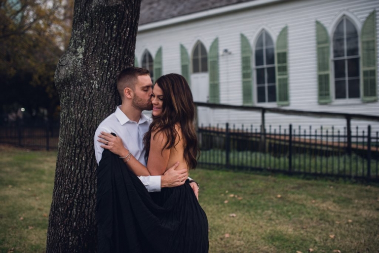 engagement couple leaning on tree