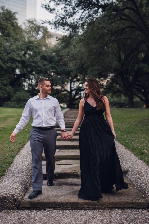 engagement couple walking down stairs