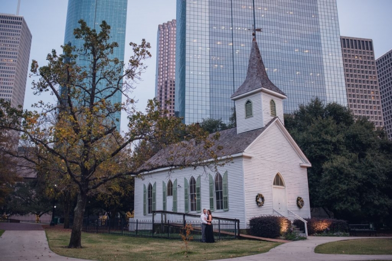 little white church in front of houston skyline