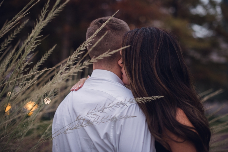 intimate couple whispering in ear