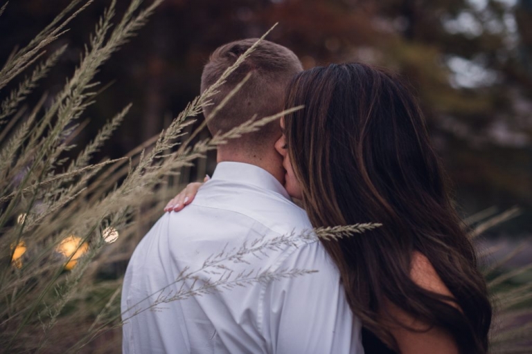 intimate couple whispering in ear