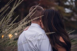 intimate couple whispering in ear