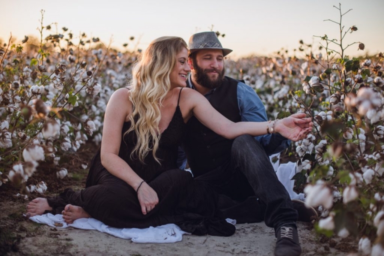 couples adventure session in cotton field