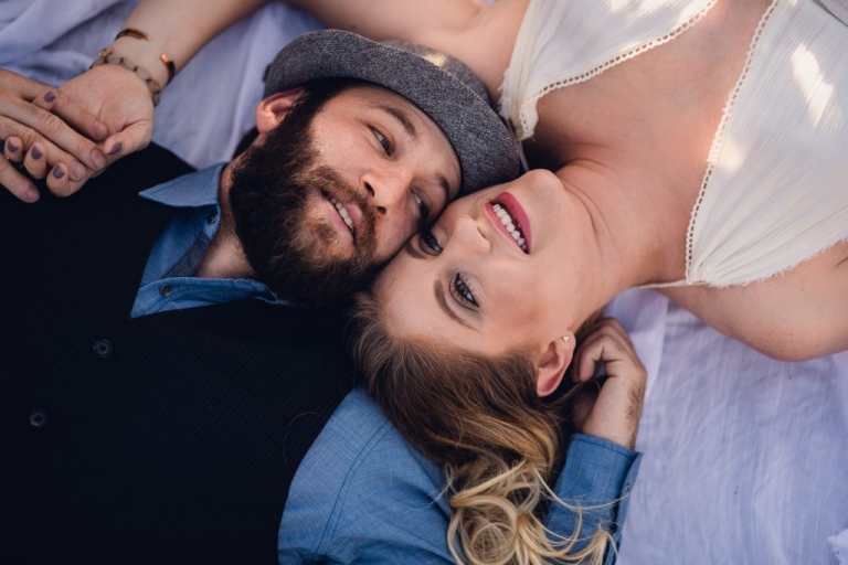 couple laying on blanket during adventure session