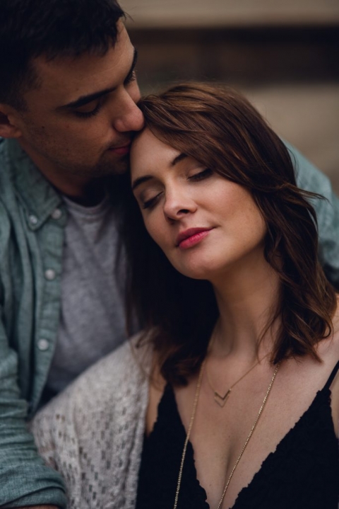 couple relaxing with forehead kiss