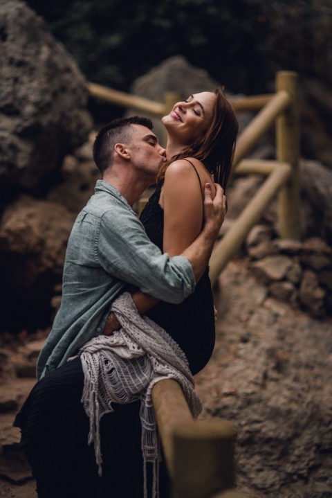 adventurous couple embracing with neck kiss