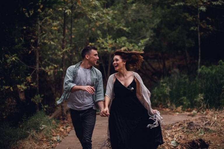 adventurous couple running and laughing