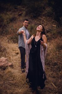 adventurous couple walking down a path