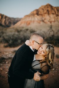 adventurous couple embracing in the desert