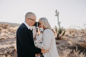 adventurous couple with their italian greyhounds in the desert
