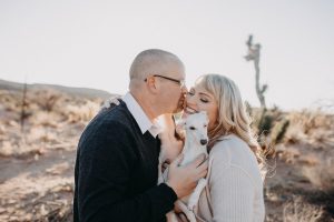 adventurous couple with their italian greyhounds in the desert