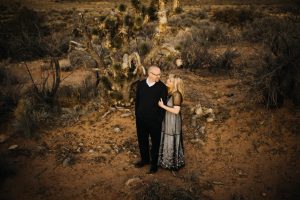 adventurous couple embracing in the desert