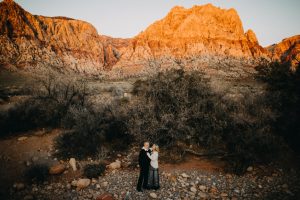 adventurous couple embracing in the desert