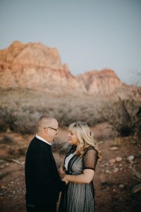 adventurous couple holding hands in the desert