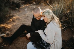 adventurous couple embracing in the desert
