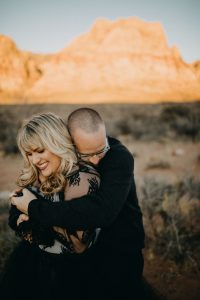 adventurous couple embracing in the desert