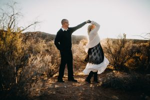 adventurous couple dancing in the desert