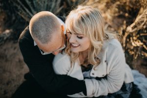 adventurous couple embracing in the desert