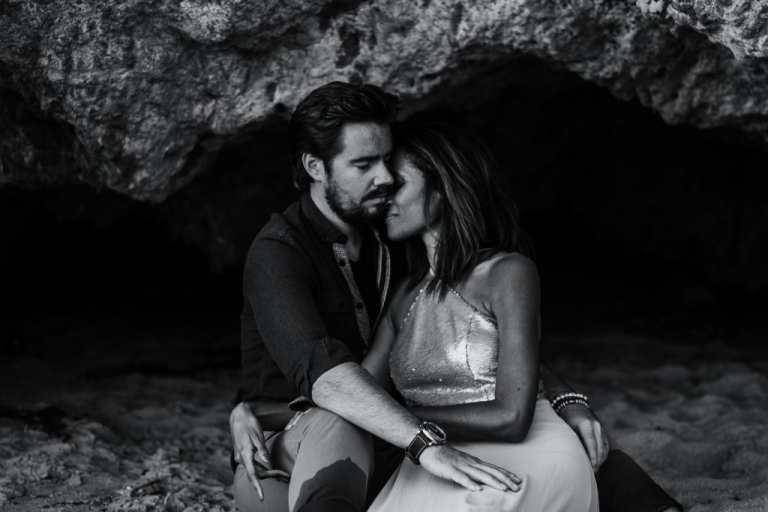 adventurous couple embracing during their session in a cave