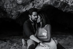 adventurous couple embracing during their session in a cave