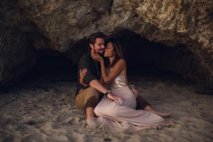 adventurous couple embracing during their session in a cave