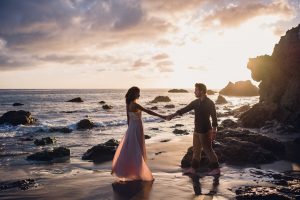 adventurous couple dancing on a beach