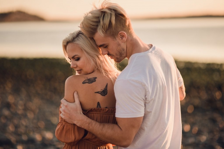 adventurous couple embracing during ruby beach engagement session