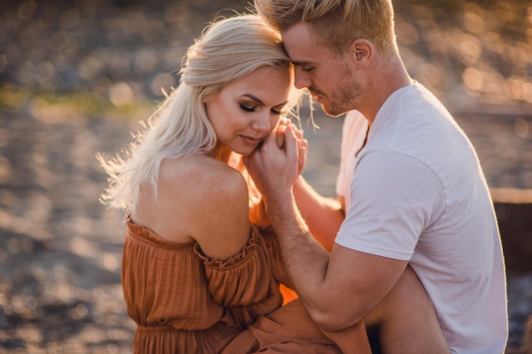 adventurous couple embracing during ruby beach engagement session