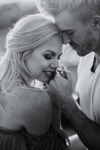 adventurous couple snuggling intimately