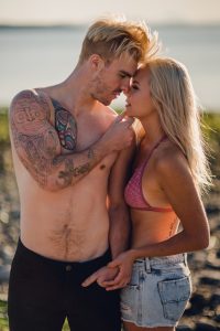 adventurous couple about to kiss on ruby beach