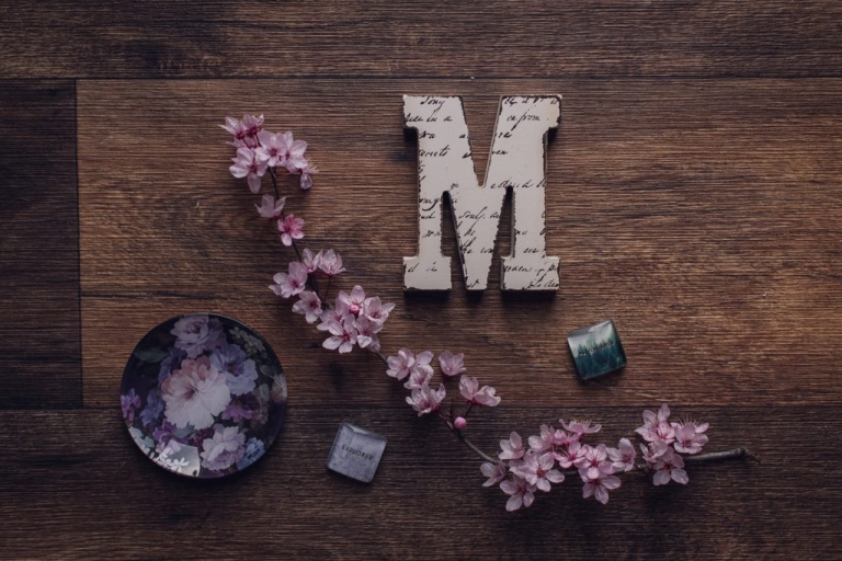 lay flat design with cherry blossoms and the letter M 
