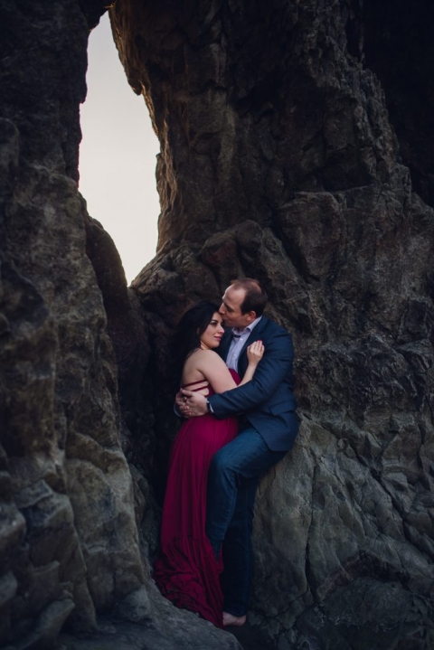 adventurous couple embracing on ruby beach during olympic national park engagement session