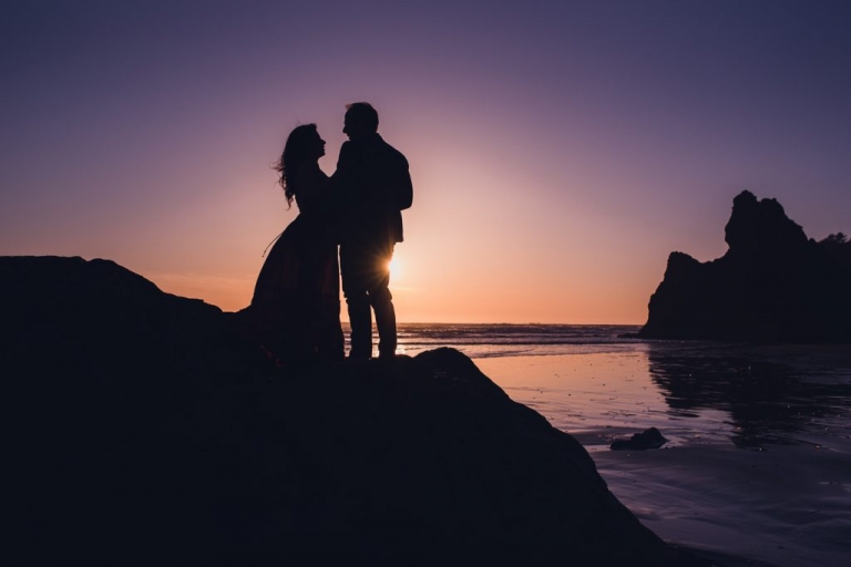adventurous couple silhouette on ruby beach at sunset during olympic national park engagement session