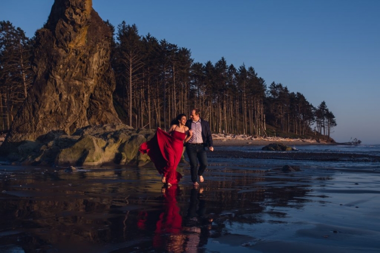 adventurous couple running on ruby beach during olympic national park engagement session