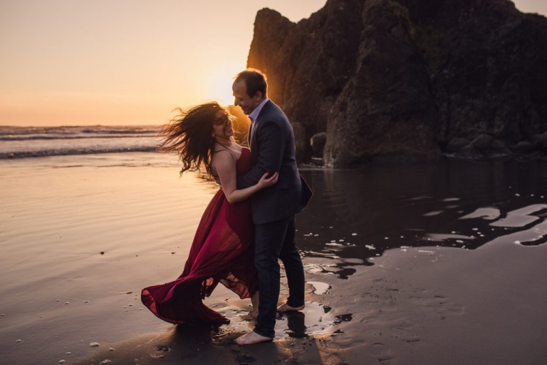 adventurous couple dancing on ruby beach during olympic national park engagement session