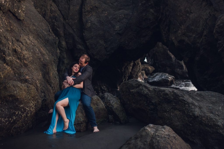 adventurous couple embracing on ruby beach during olympic national park engagement session