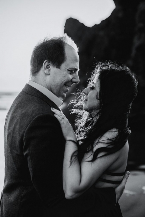 adventurous couple embracing on ruby beach during olympic national park engagement session