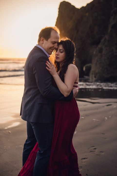 adventurous couple embracing on ruby beach during olympic national park engagement session