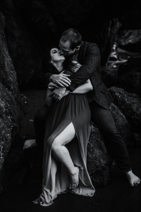adventurous couple embracing on ruby beach during olympic national park engagement session
