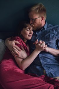 couple's lifestyle snuggle session, lifestyle photo session, in-home photo session, couples, couples lifestyle photo session, love, couples lifestyle photographer, pink dress, blue button up shirt